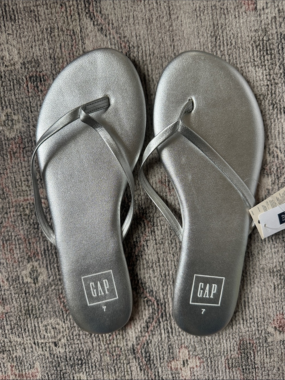 Silver-toned genuine leather flip flops.
